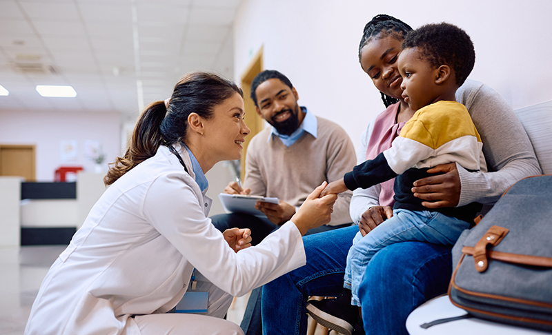 Doctor greeting a family of 3